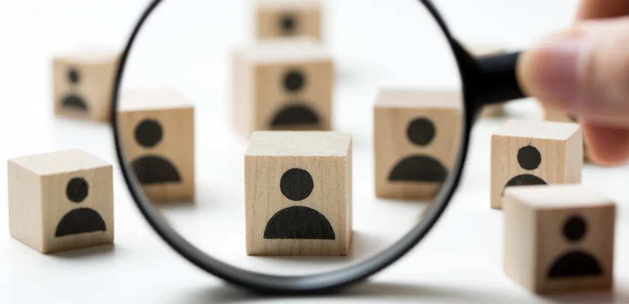 Symbolbild Personalcontrolling: Personalstruktur wird durch Lupe betrachtet